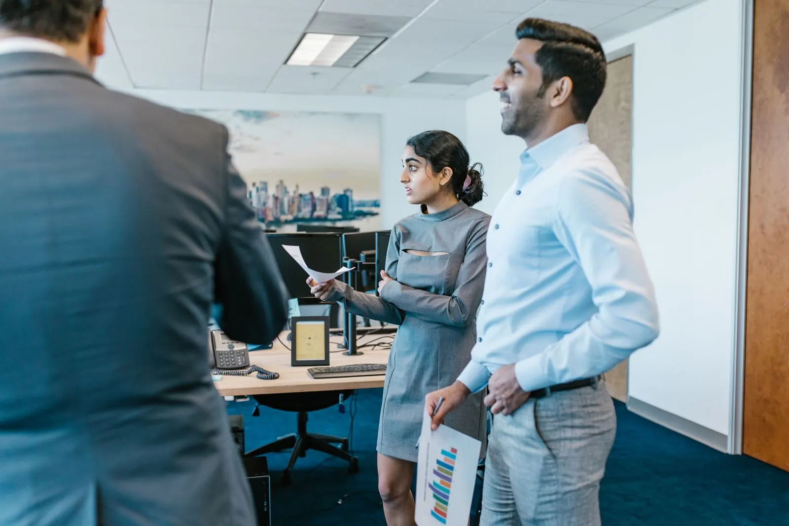 Two professionals discussing plans in a modern office